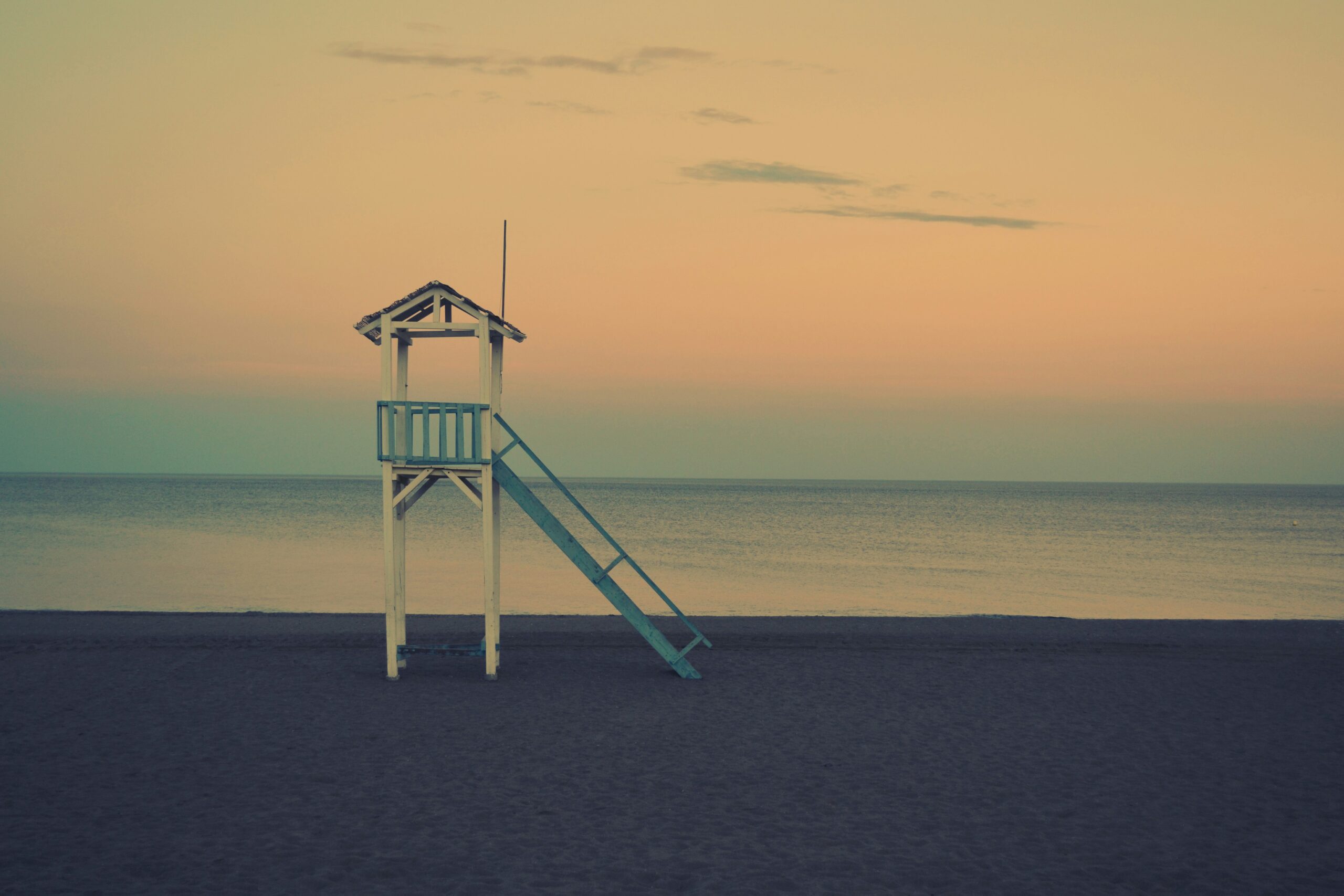 moody beach sunset with lifeguard tower